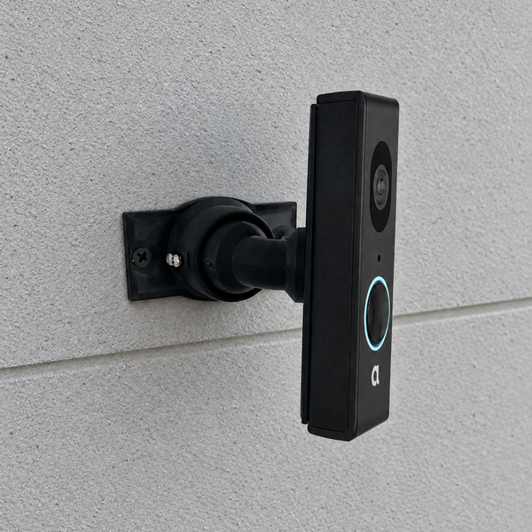 Alula CAM-DB-JS1 on adjustable 15–90 degree swivel mount, right-facing view on light gray smooth exterior masonry