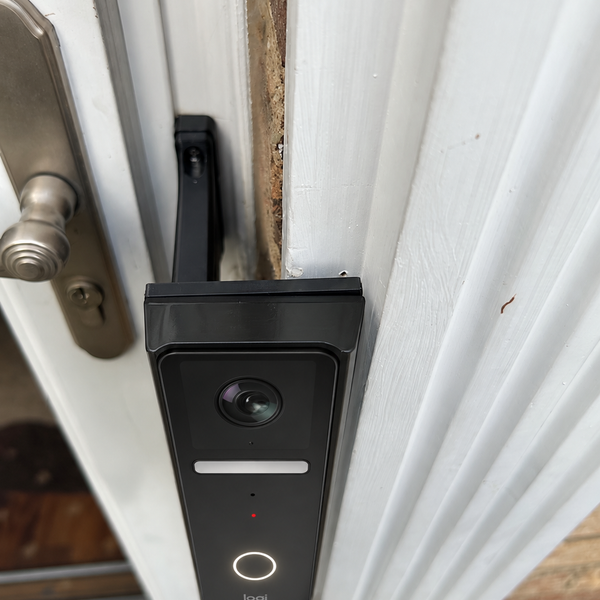 Logitech Circle View doorbell on black full offset brick extension mounted to trim, alternate installation view