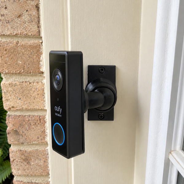 Eufy S220 battery video doorbell installed on 15–90 degree adjustable swivel mount, left-facing installation
