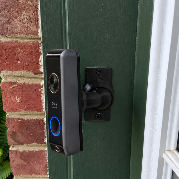 Eufy S330 WIRED video doorbell installed on 15–90 degree adjustable swivel mount, left-facing installation
